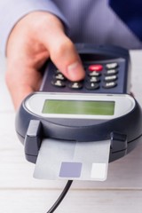Man entering his pin on terminal