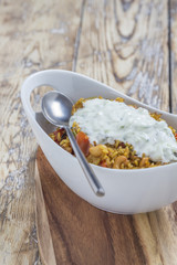 Bowl with curry flavored rice chicken and vegetables
