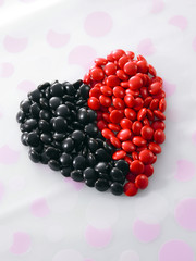 red and black color chocolate candy form a heart shape