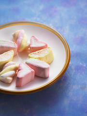 close up plate of marshmallow on the blue color background