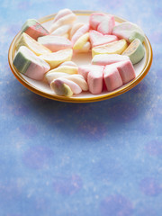 plate of marshmallow on the blue color background