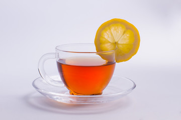 Glass cup of tasty black tea