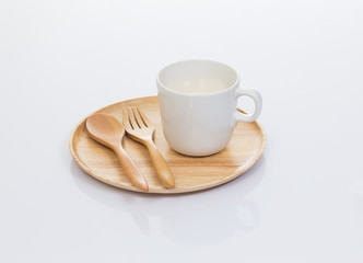 Cup of soy milk with wood plate isolated on white background