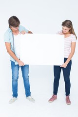 Hipster couple holding poster
