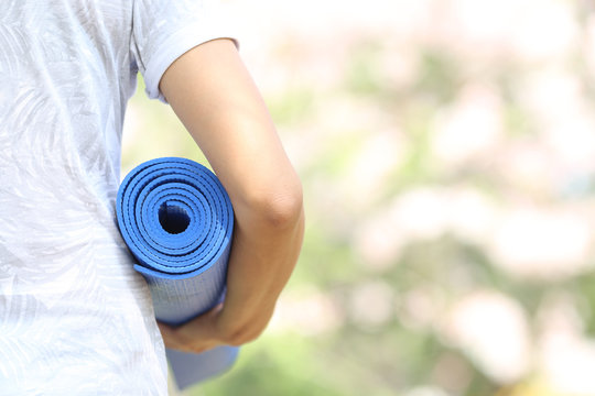 Young Woman Holding A Yoga Mat