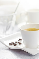 Cup of coffee on white wooden background