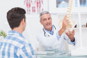 Doctor explaining anatomical spine to his patient