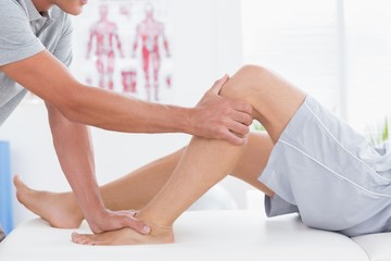 Obraz na płótnie Canvas Man having leg massage