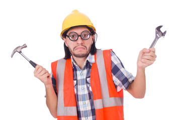 Funny young construction worker with hammer and wrench  isolated