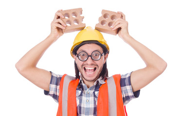 Funny young construction worker with broken brick isolated on