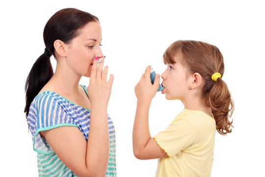 girl smoking cigarette and little girl with inhaler