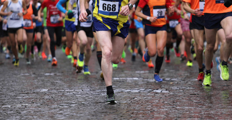 runners during marathon while it is raining