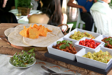 Mexican food - chilli, guacamole, tortillas and nachos