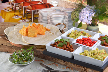 Mexican food - chilli, guacamole, tortillas and nachos