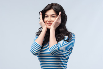 Studio portrait of a young woman. Isolated grey background. Ow y