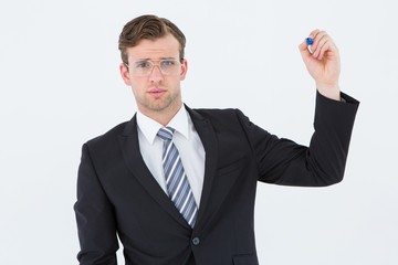 Geeky businessman writing with marker