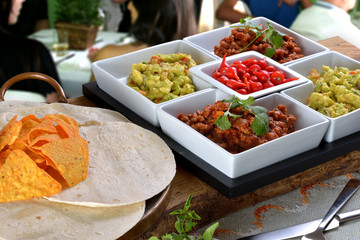 Mexican food - chilli, guacamole, tortillas and nachos