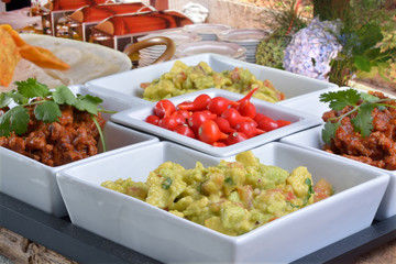 Mexican food - chilli, guacamole, tortillas and nachos