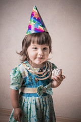 funny girl eating cake in a festive cap in vintage style