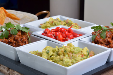 Mexican food - chilli, guacamole, tortillas and nachos