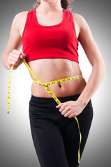 Young girl with centimeter in dieting concept