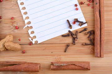 paper, cinnamon, star anise and cloves on wood