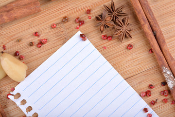 paper, cinnamon, star anise and cloves on wood
