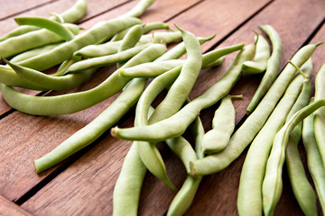 green string beans on wooden table