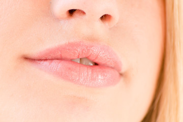 Obraz premium image of beautiful blonde girl plump lips on a white background closeup