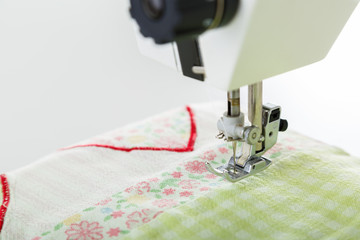 Working on sewing machine. Close look of hands and needle