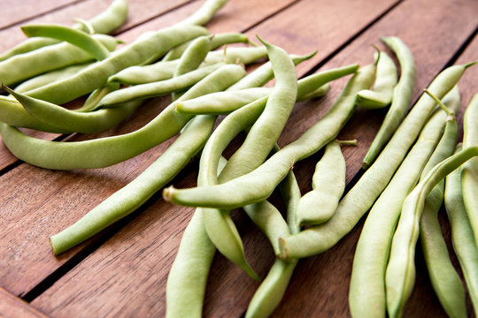 green string beans on wooden table