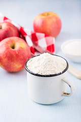 Cup of flour, butter, red apples and sugar