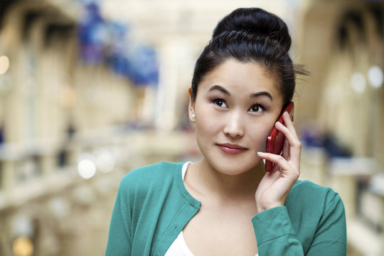 Beautiful asian calling by mobile phone