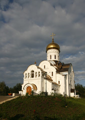 Fototapeta na wymiar White Orthodox Cathedral with Golden domes.
