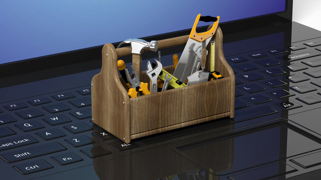 Toolkit with various tools on laptops keyboard