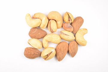 Pile of mixed nuts isolated on a white background.
