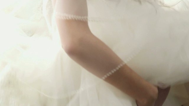 young bride dressing up garter for wedding ceremony