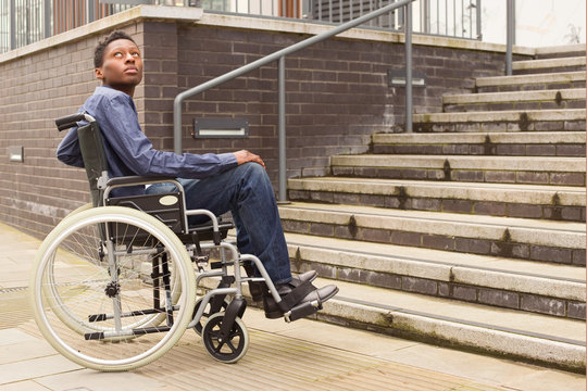 young man in a wheelchair waiting for help