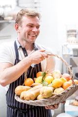 Fototapeta premium Man with basket full of fruits