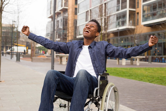 a young wheelchair user celebrating.
