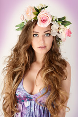 Beautiful women supermodel in wreath of flowers portrait.