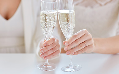 close up of lesbian couple with champagne glasses