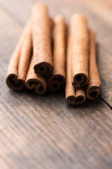 Cinnamon sticks on rustic wood