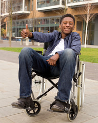 Fototapeta na wymiar young wheelchair user showing the thumbs up symbol