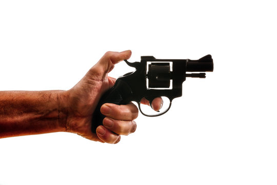 Silhouette of a mans hand with a handgun