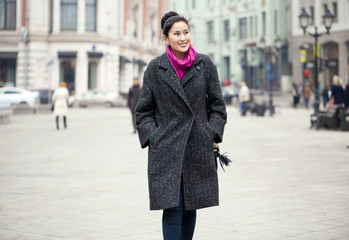 Young beautiful asian woman in stylish gray coat