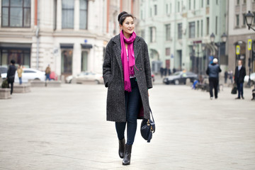 Obraz premium Young beautiful asian woman in stylish gray coat
