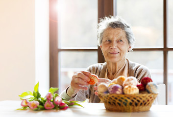 Senior woman with easter eggs