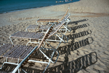 Plastic deck chairs on the beach