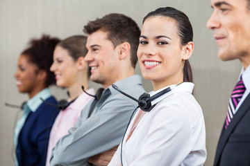 Customer Service Representative Standing With Colleagues And Man